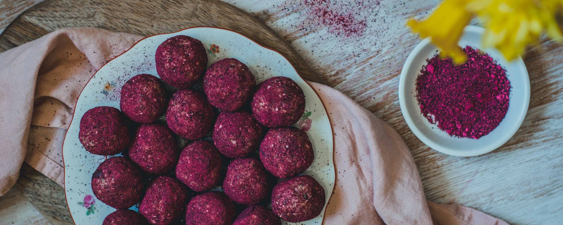 a featured image for beetroot powder covered energy bliss balls