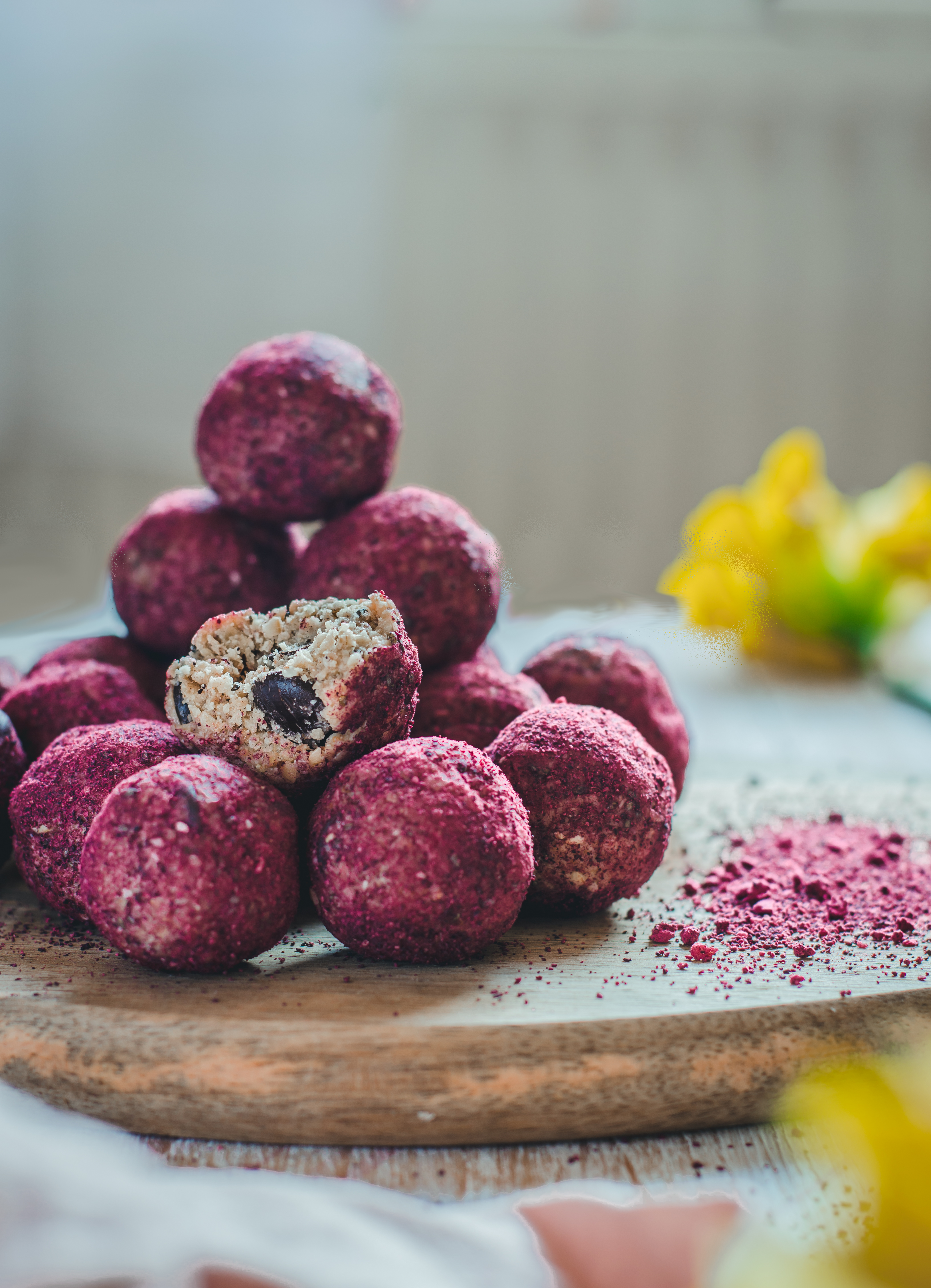 a stack of energy bliss balls coated with beetroot powder for spring