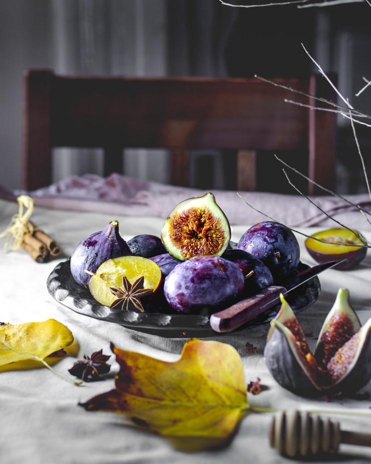a rustic plate of plums, figs and spices to make a crumble tart