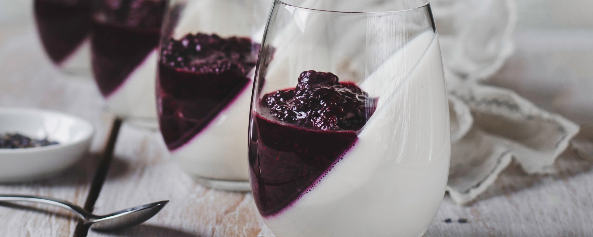 lavender infused blackberries on top of panna cotta desserts