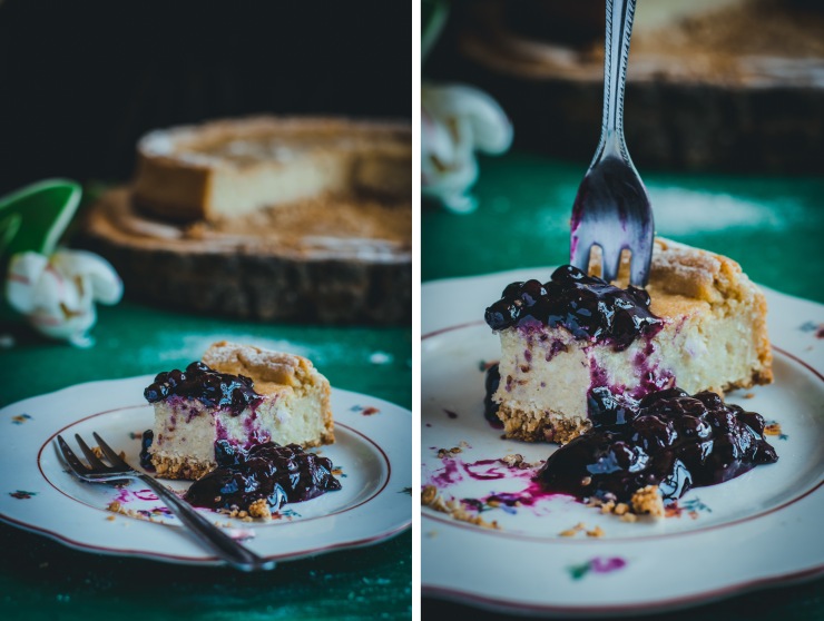 serving a slice of vegan coconut millet cheesecake with warm blueberry compote